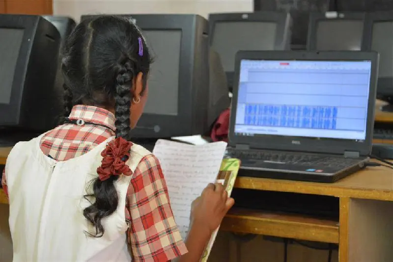 Students in a School Radio club recording a programme